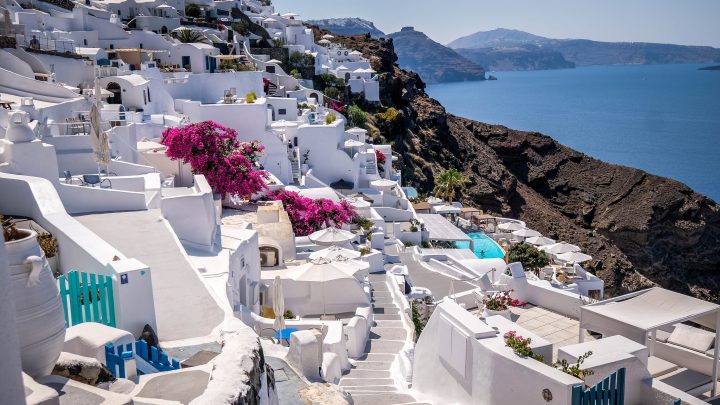 Santorini, Greece Narrow streets, Cyclades architecture hotels houses and  cafes over the caldera in Oia santorini greek islands against mediterranean
